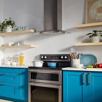 A Maytag® range hood over a stove in a modern kitchen