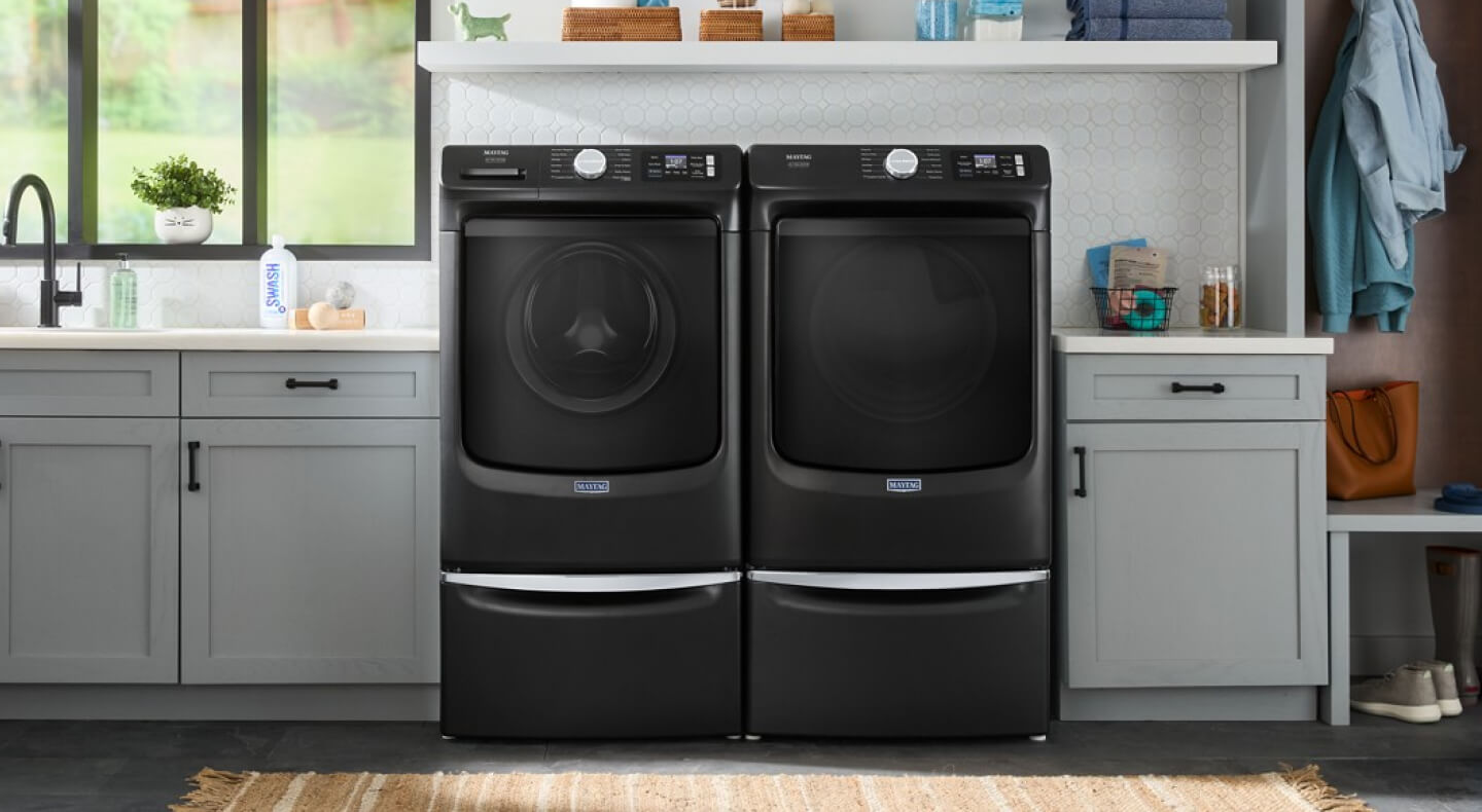 A laundry room with a Maytag® Pet Pro front load laundry set