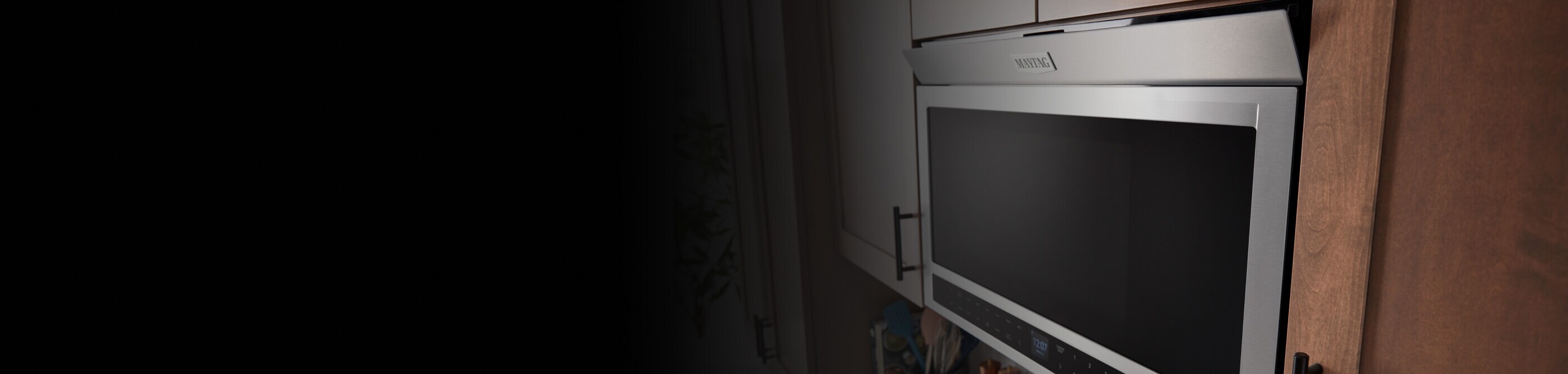 Flush Maytag® microwave against cabinets with its vent open