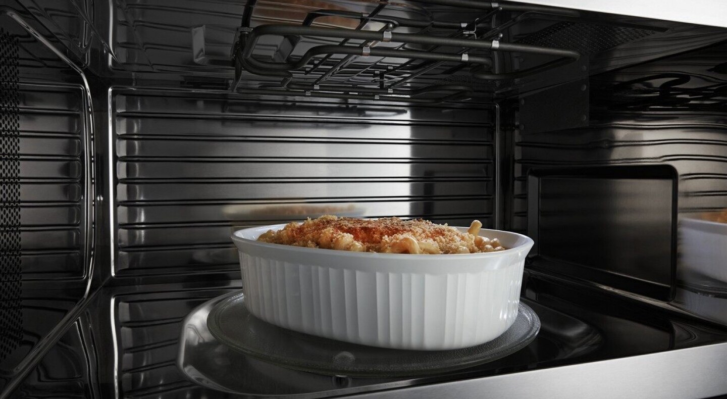 A closeup of the interior of a convection Maytag® microwave cooking a pasta meal A closeup of the interior of a convection Maytag® microwave cooking a pasta meal