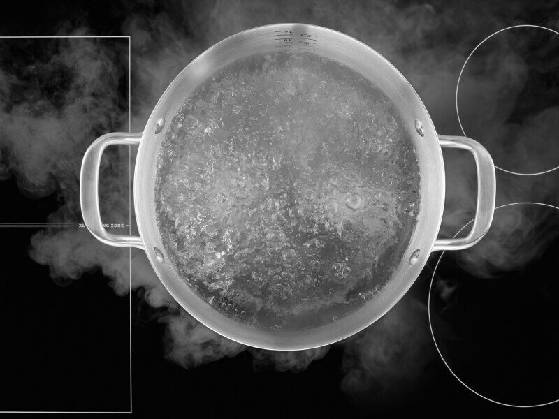 Birds-eye view of water boiling in a stockpot on an induction cooktop