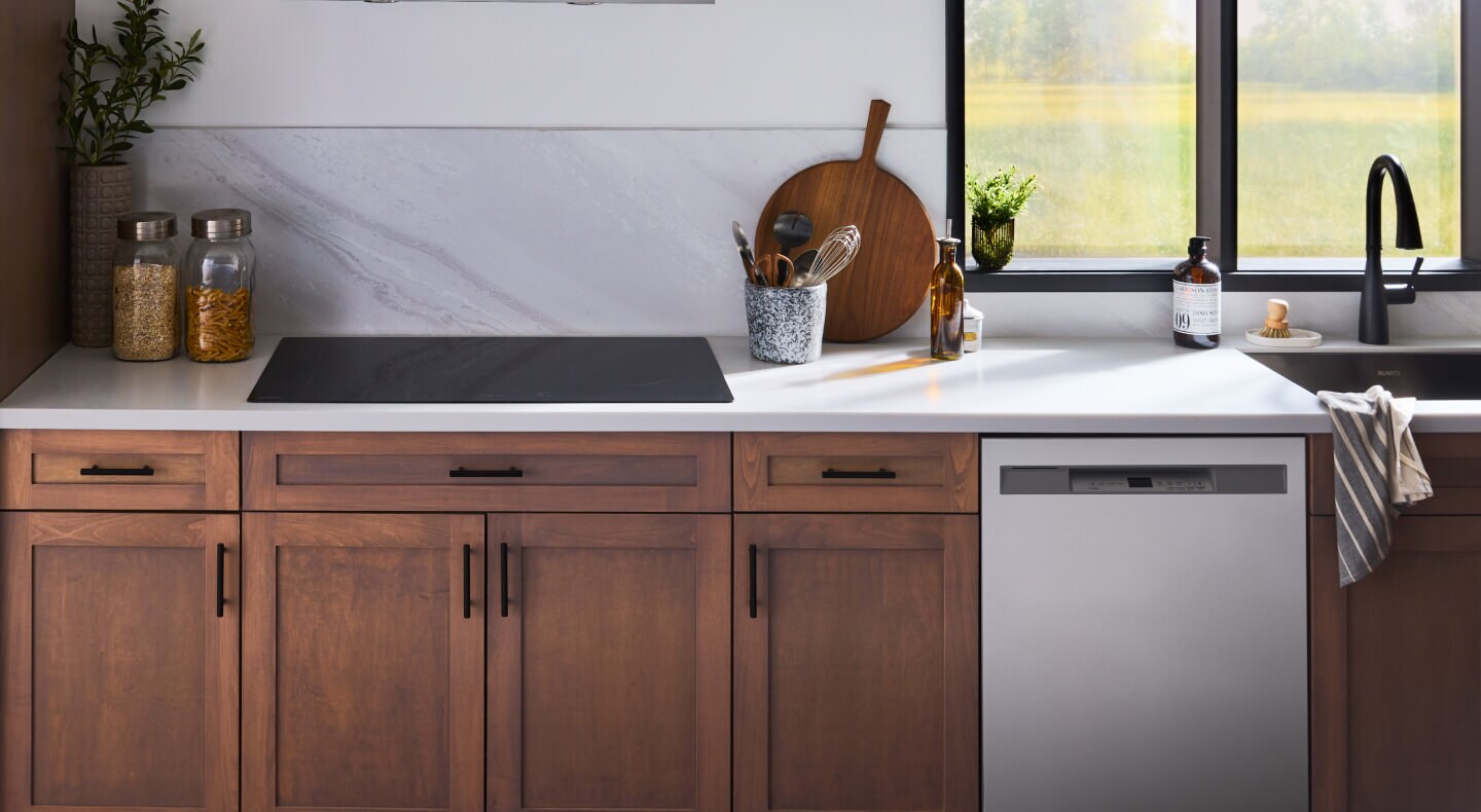 Induction cooktop installed above rich brown cabinetry