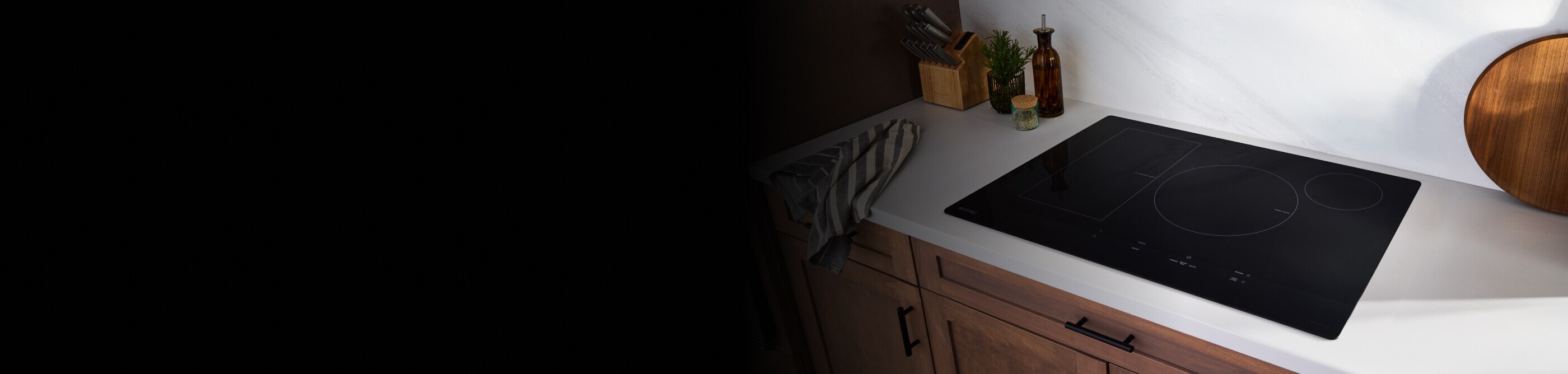 Maytag® induction cooktop installed in a white countertop