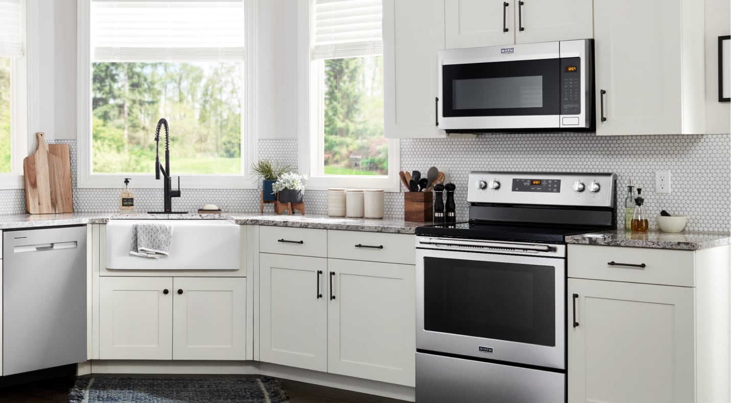 Maytag® microwave hood combination over Maytag® range in white kitchen Maytag® microwave hood combination over Maytag® range in white kitchen