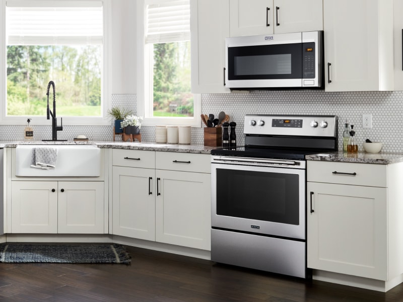 Maytag® microwave hood combination over Maytag® range in white kitchen Maytag® microwave hood combination over Maytag® range in white kitchen