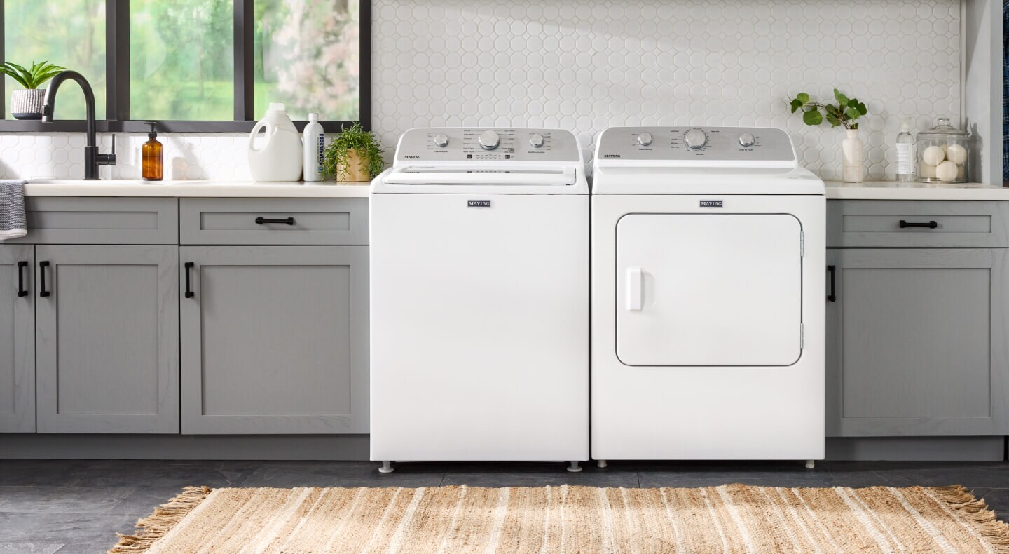 White Maytag®  top load laundry pair in gray cabinetry