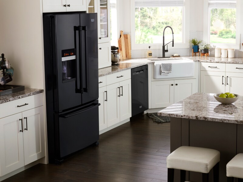 Modern kitchen featuring a black, French door refrigerator