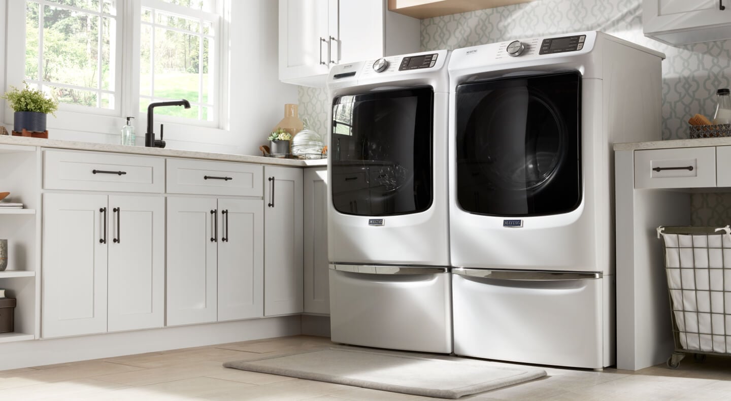 A Maytag® front load washer and dryer in a modern laundry room