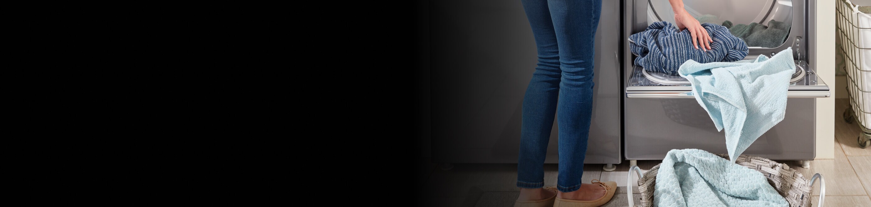 A close up of a person removing laundry from a Maytag® dryer