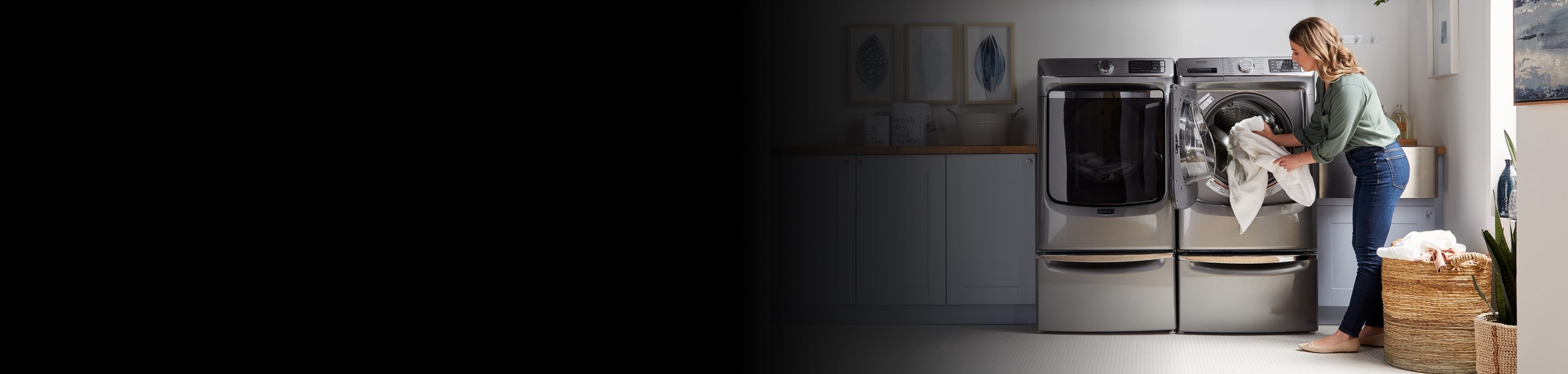 A person taking laundry out of a Maytag® dryer