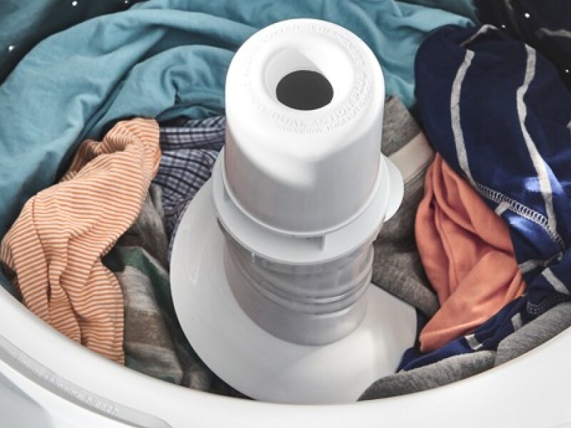 Assorted clothes tumbling in a dryer