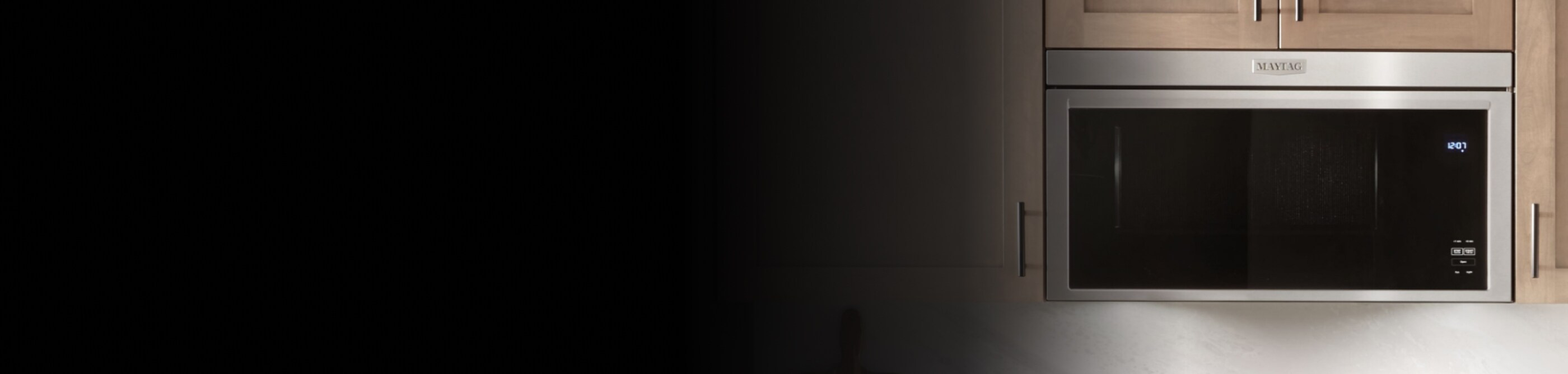 Maytag® over-the-range microwave in light brown cabinetry