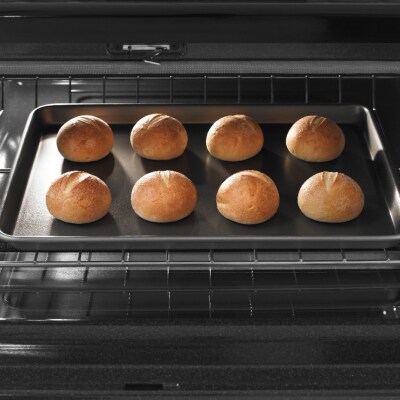 Rolls on a baking sheet inside an oven
