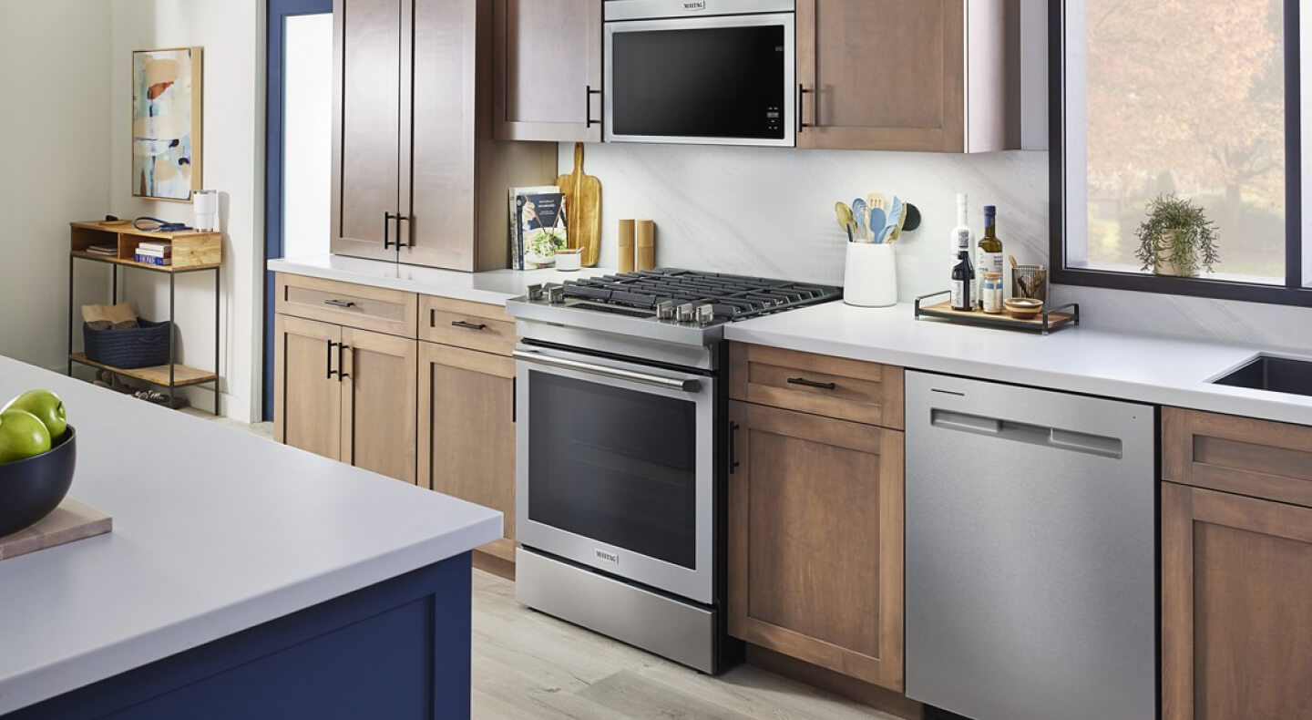 Maytag® slide-in range in a kitchen with light wood cabinetry