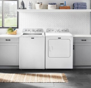 White top load laundry set in a laundry room
