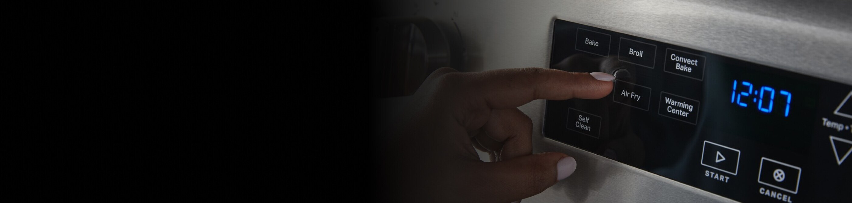 Person selecting a setting on a Maytag® range