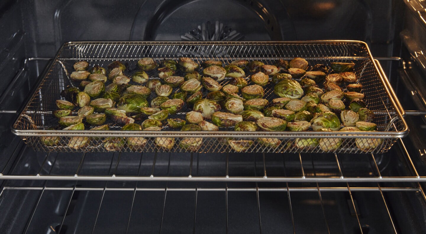 Brussel sprouts cooking in an air frying oven Brussel sprouts cooking in an air frying oven