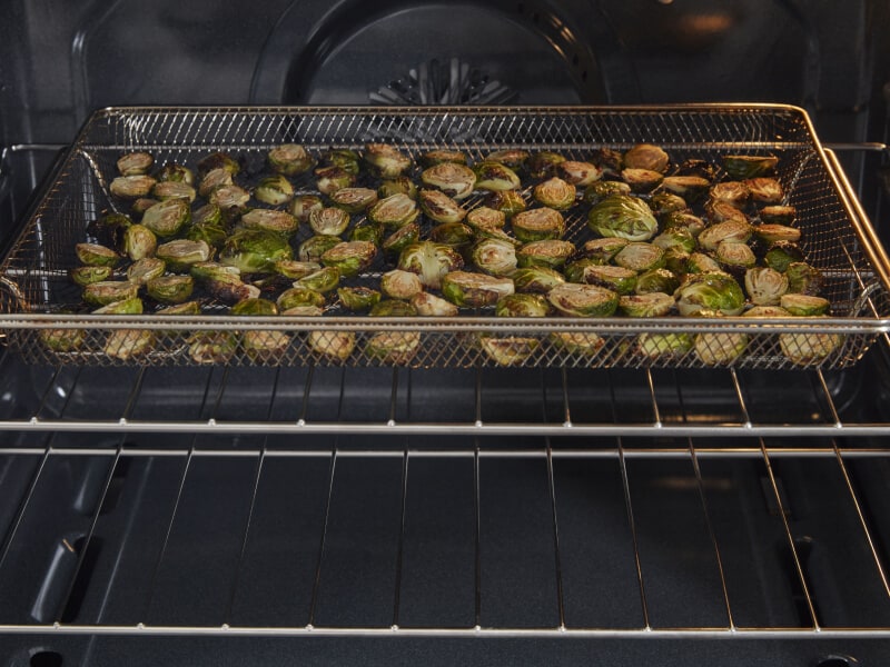 Brussel sprouts cooking in an air frying oven Brussel sprouts cooking in an air frying oven