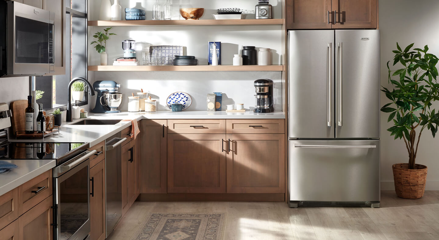Stainless steel Maytag® French door in brown cabinetry
