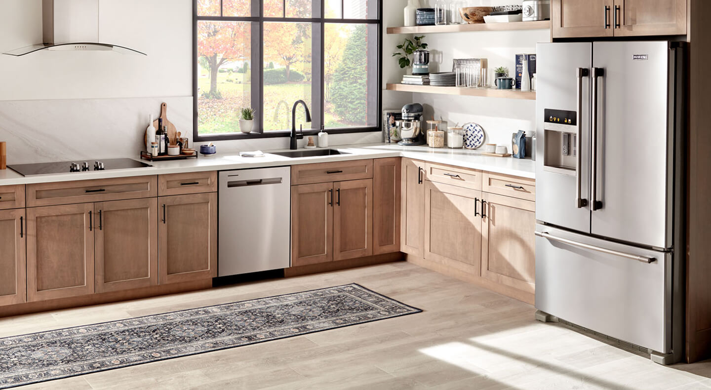 Stainless steel Maytag® French door with an exterior ice and water dispenser