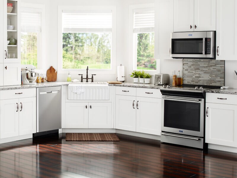 Stainless steel appliances in open kitchen with white cabinetry Stainless steel appliances in open kitchen with white cabinetry