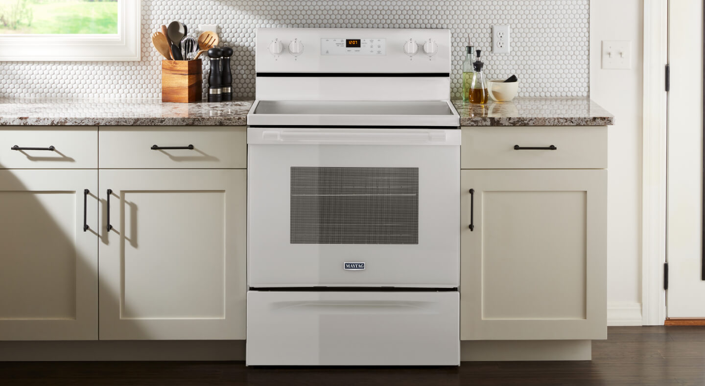White Maytag brand oven in between white cabinetry White Maytag brand oven in between white cabinetry