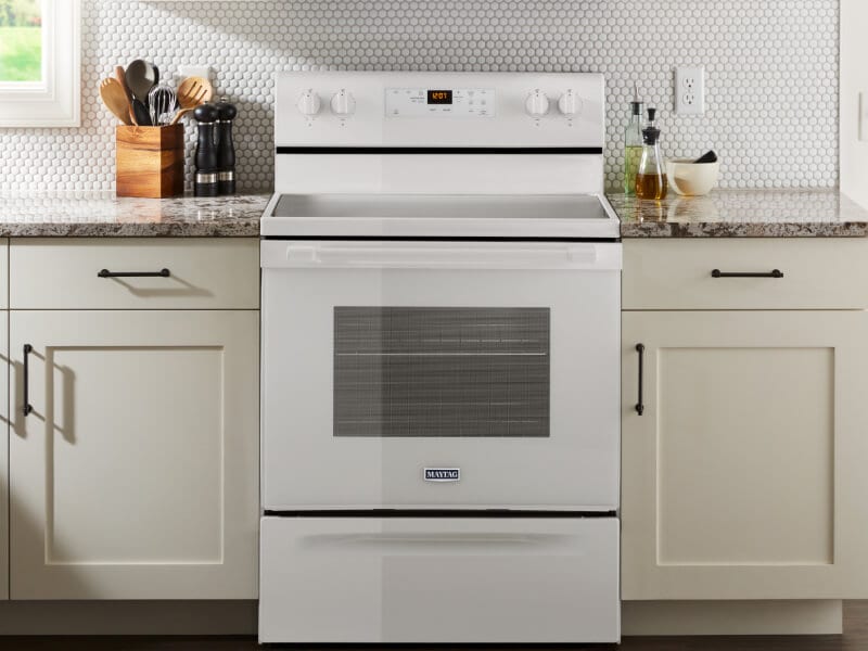 White Maytag brand oven in between white cabinetry White Maytag brand oven in between white cabinetry
