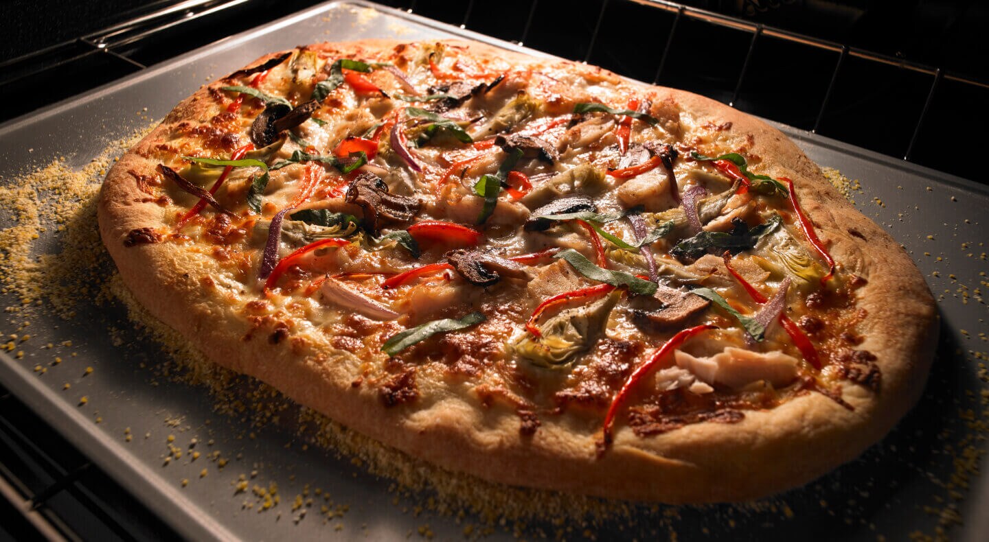 Pizza cooking inside an oven Pizza cooking inside an oven