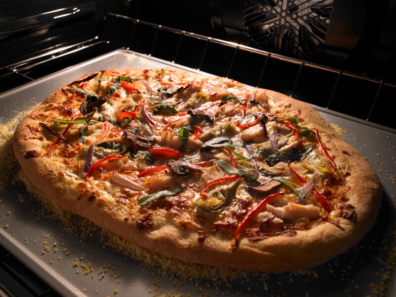 Pizza cooking inside an oven Pizza cooking inside an oven