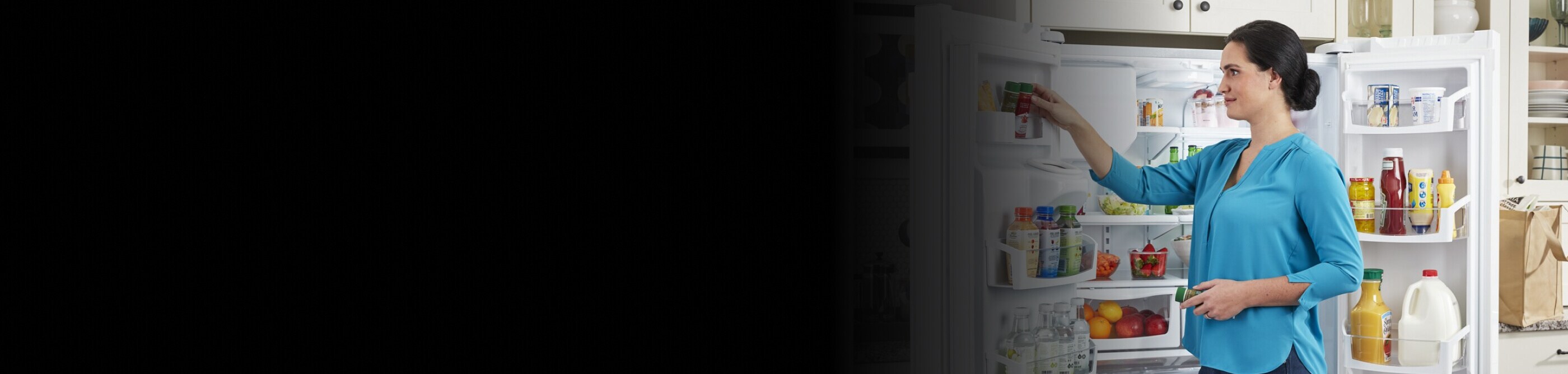 Person placing food in side door of refrigerator 