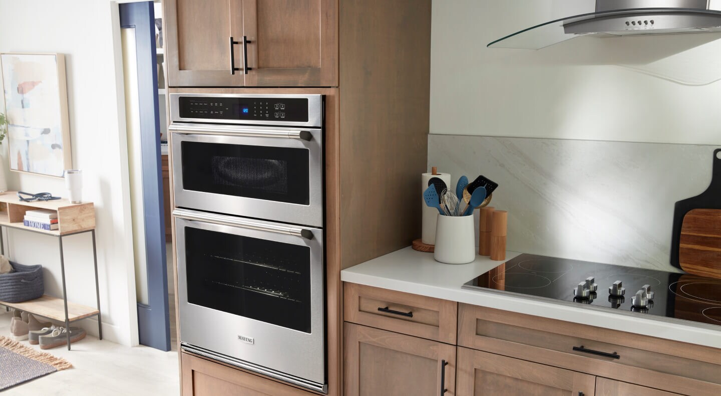 A Maytag® Double Wall Oven and cooktop in a modern kitchen