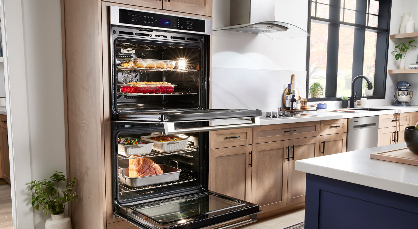 A Maytag® Double Wall Oven and cooktop in a modern kitchen