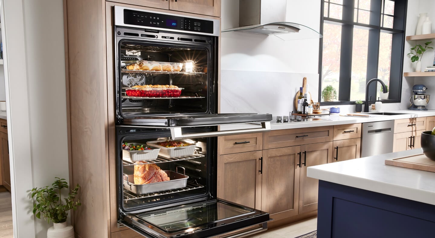A Maytag® Double Wall Oven and cooktop in a modern kitchen