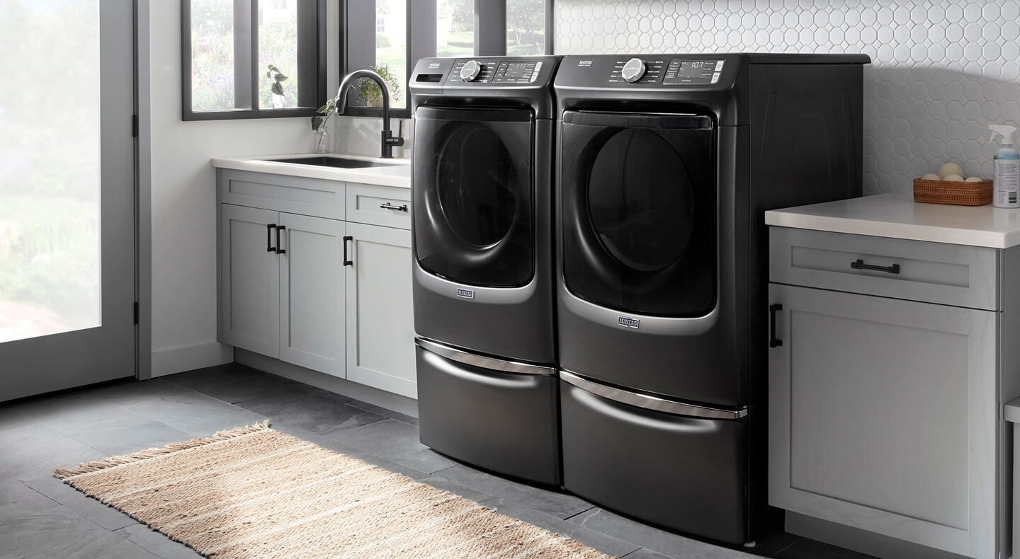 Front load washer and dryer in a laundry room