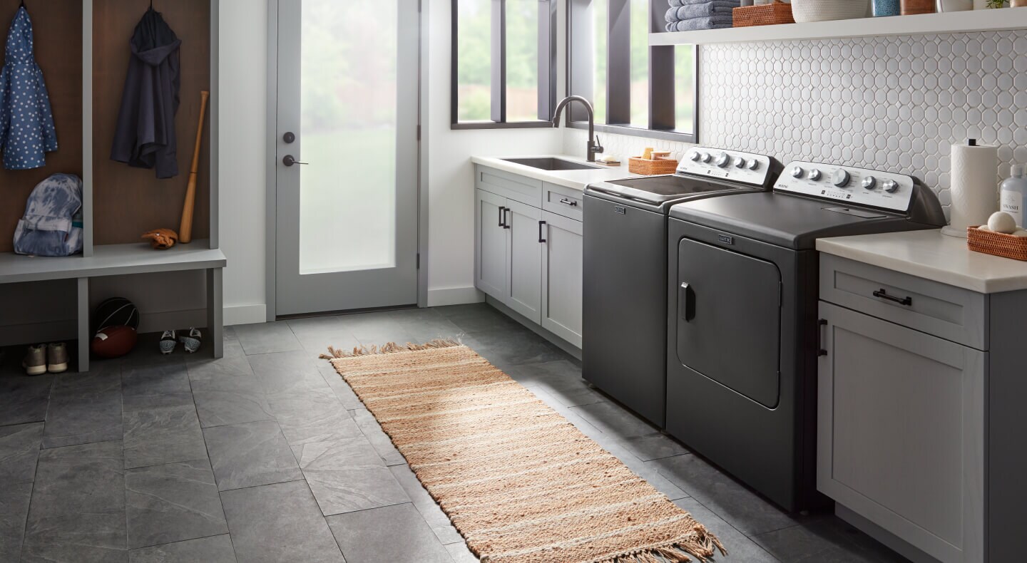 A laundry area with a Maytag® top load washer and dryer set