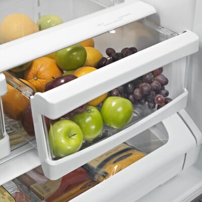 Produce in a cracked open crisper drawer