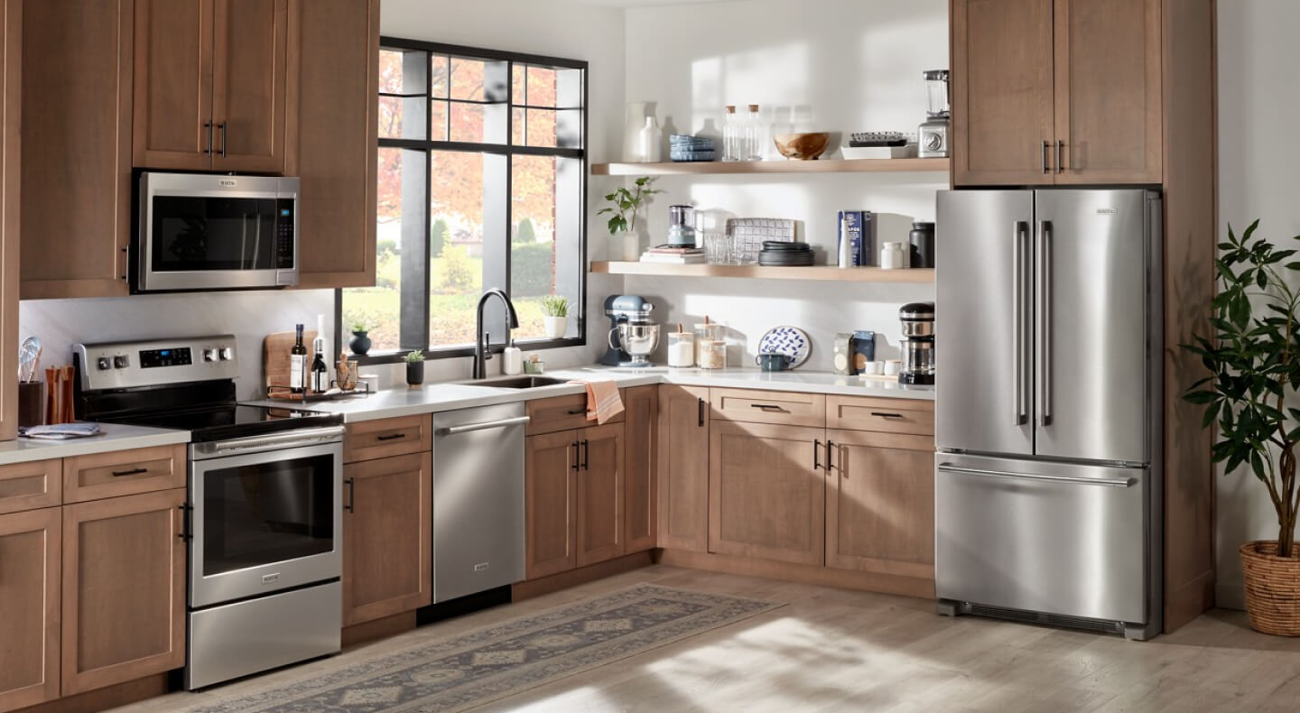 Stainless steel Maytag® French door refrigerator in brown cabinetry