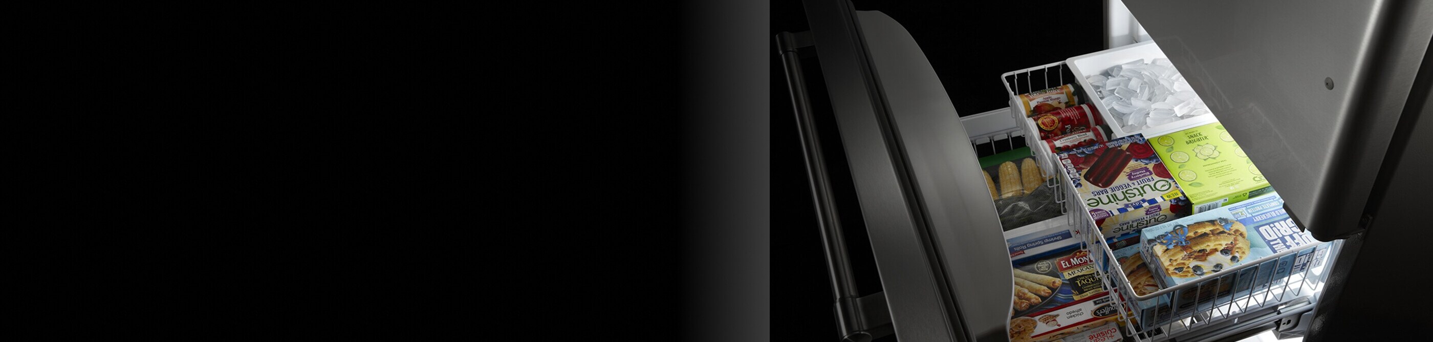 Open freezer drawer stocked with groceries