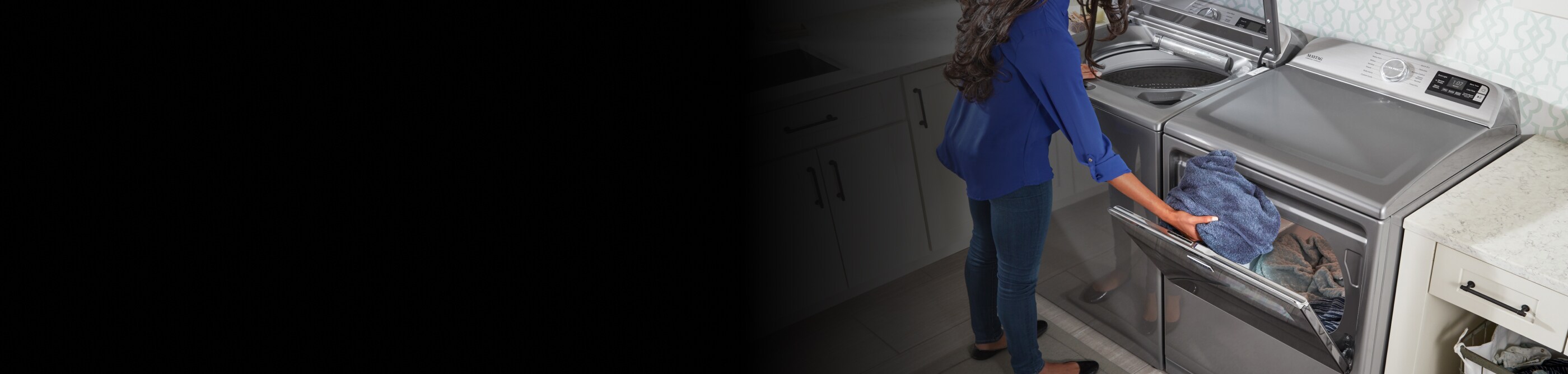 Person at open washer and dryer