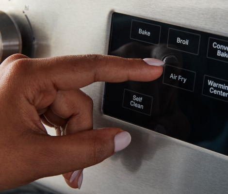 Hand pressing Air Fry button