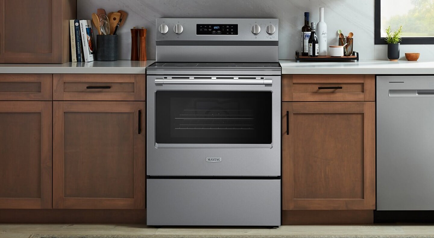 A Maytag® range in a kitchen with brown cabinets