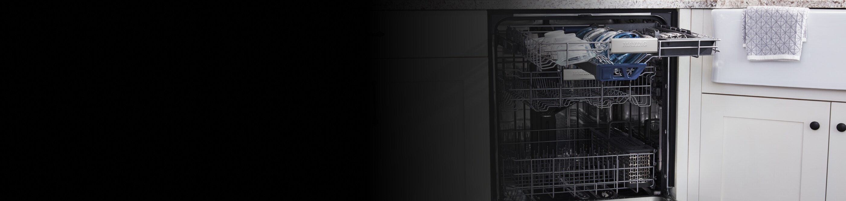 Open dishwasher set in white cabinetry