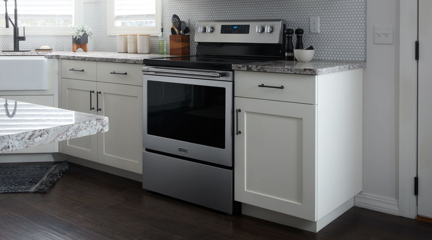 A profile view of a stainless steel Maytag® oven in a contemporary kitchen A profile view of a stainless steel Maytag® oven in a contemporary kitchen