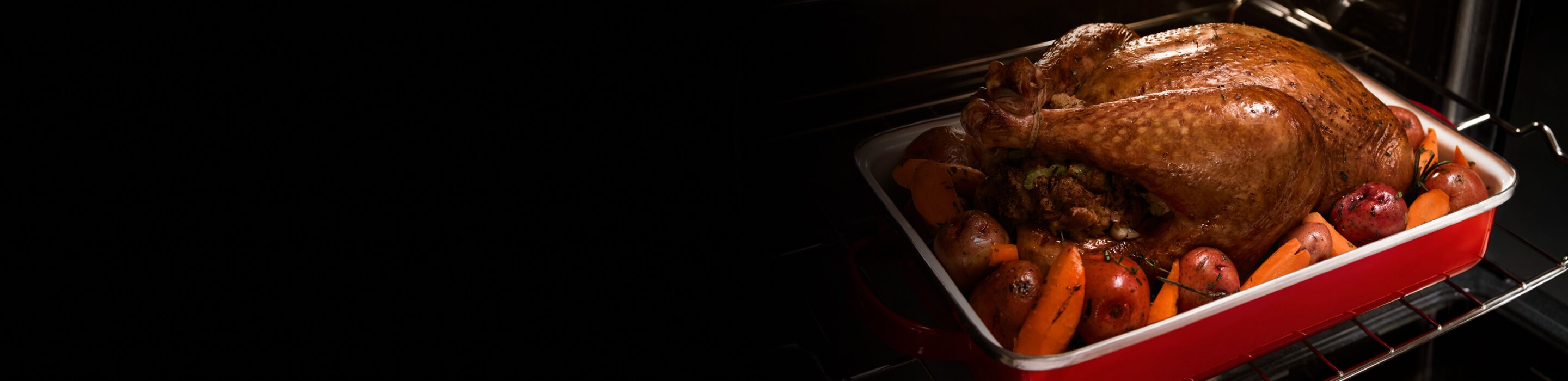 A roasted turkey and vegetables in a baking dish