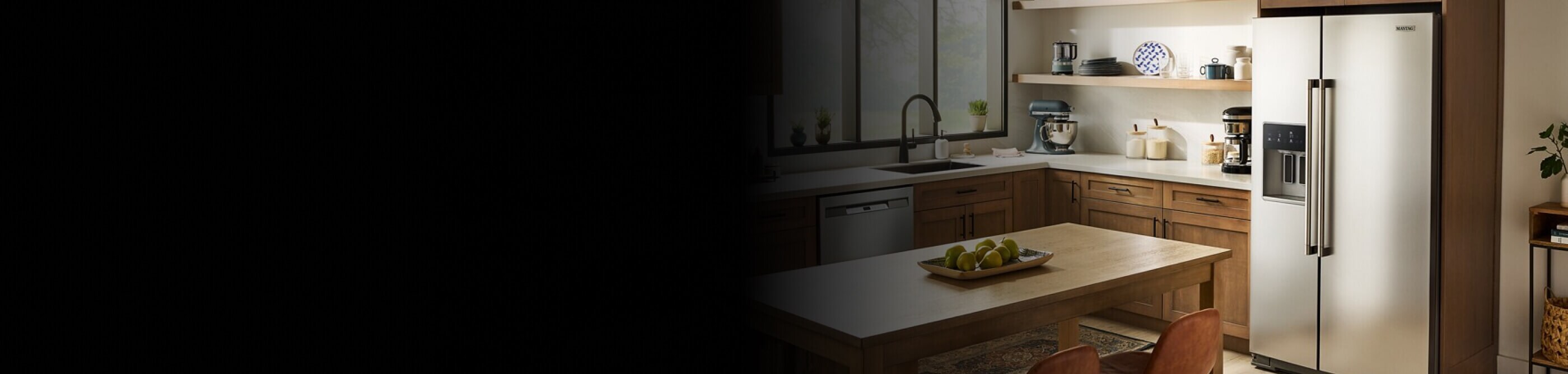 Kitchen with stainless steel Maytag® side-by-side refrigerator with an external ice and water dispenser