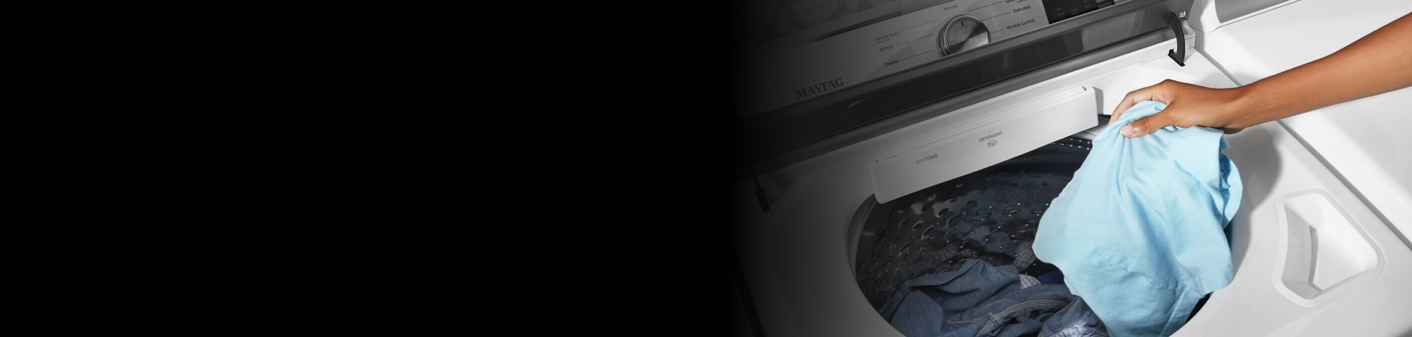A person adding laundry to a Maytag® washer