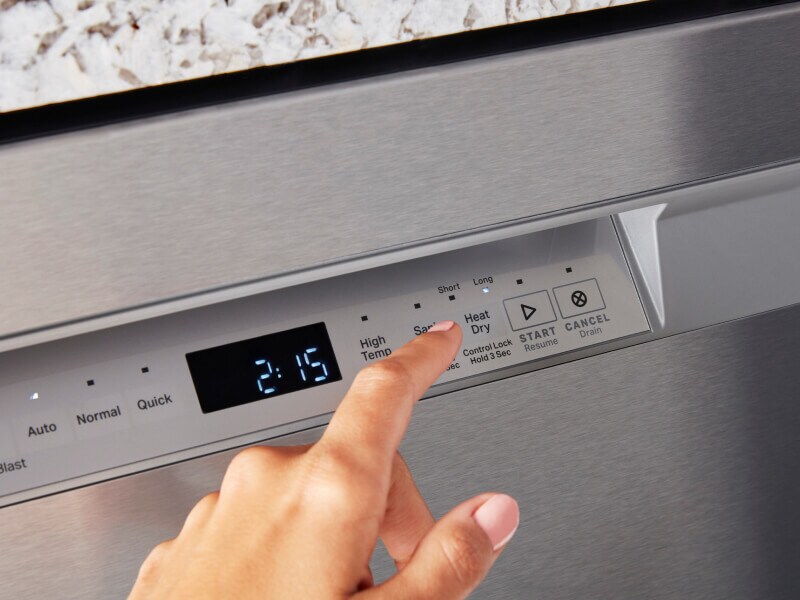 Person pushing dry cycle button on a dishwasher