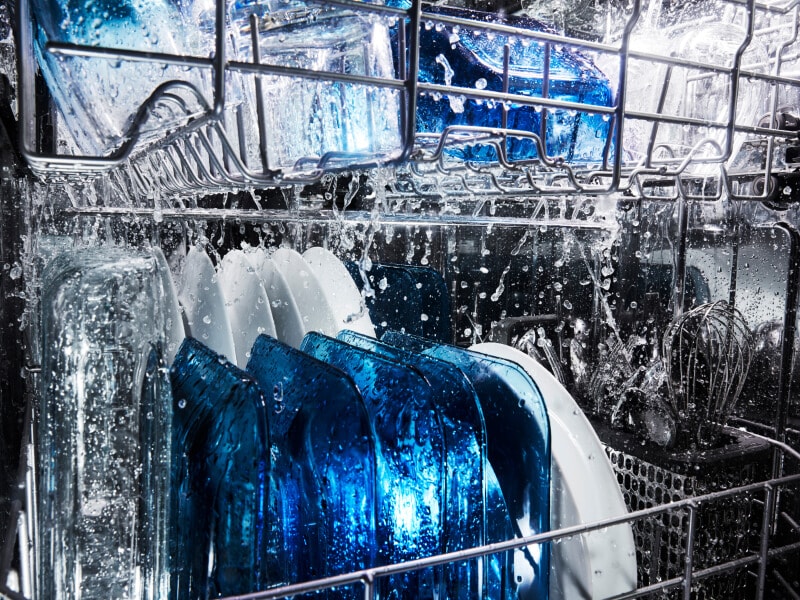 Water running on dishes in a dishwasher