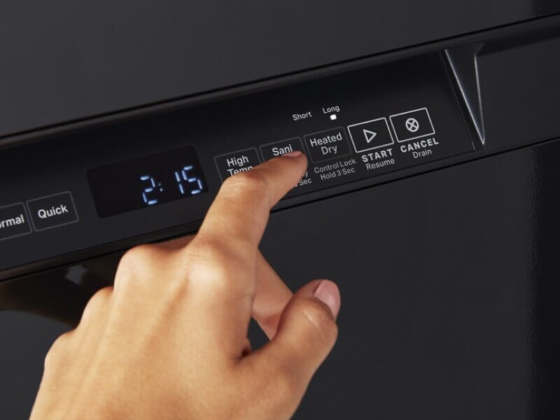 Person choosing cycle on black dishwasher