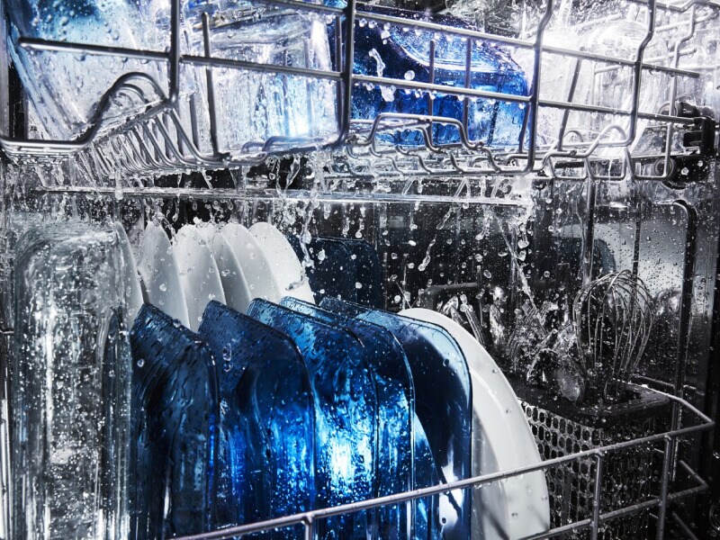 Water running over dishes in dishwasher